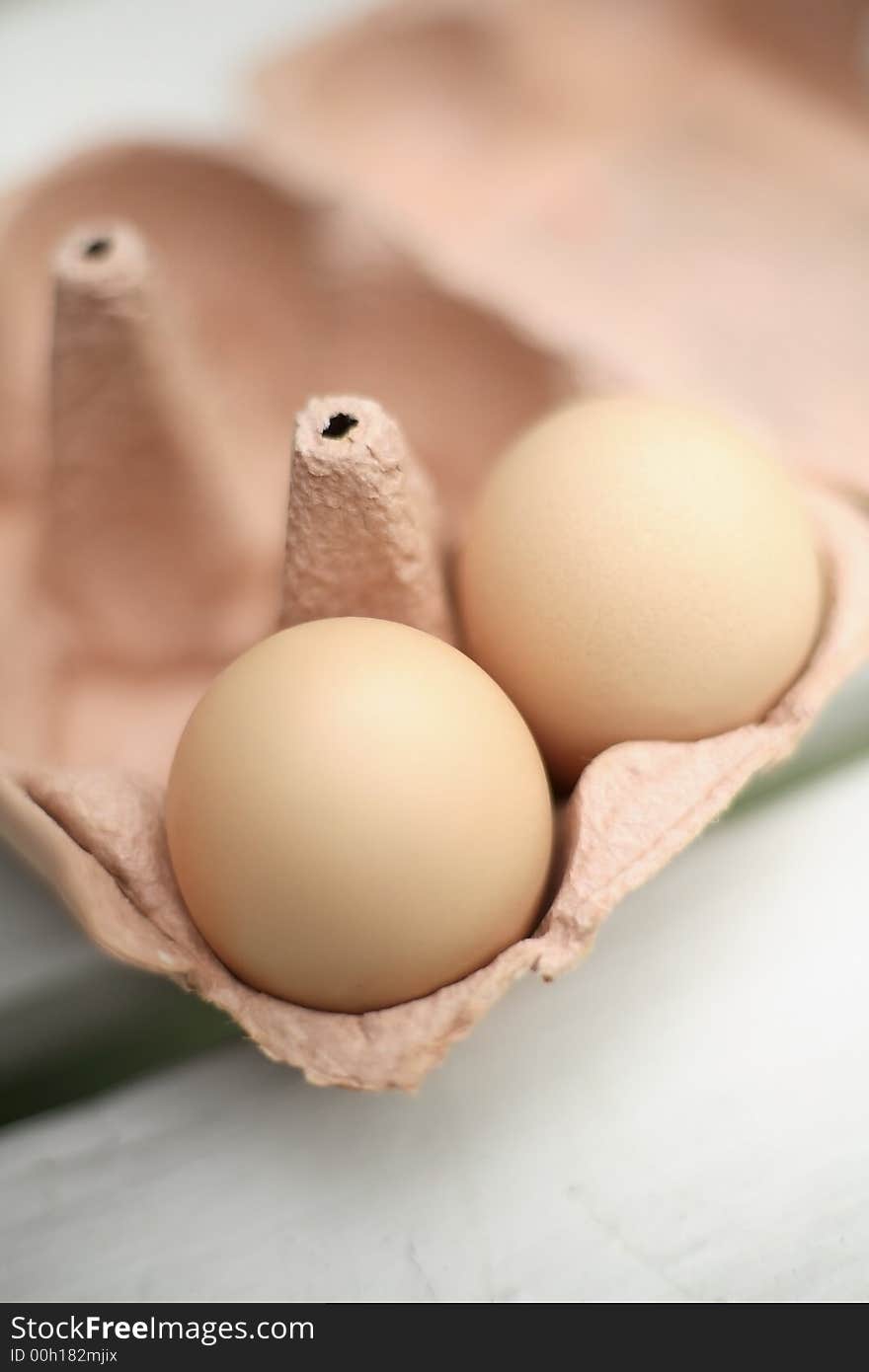 Two Organic freerange eggs in egg box