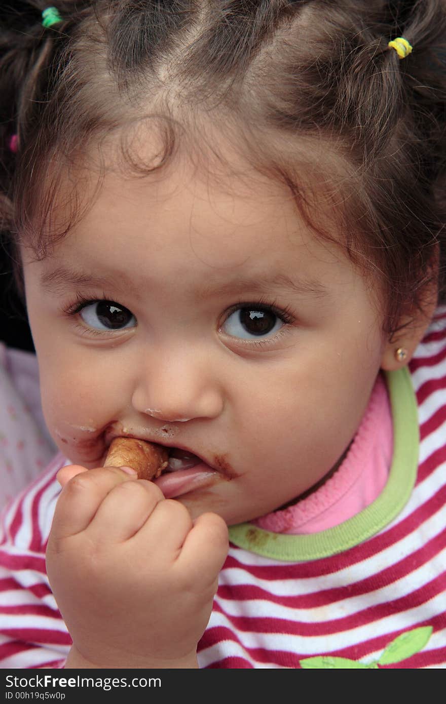 One year old baby eating an ice-cream