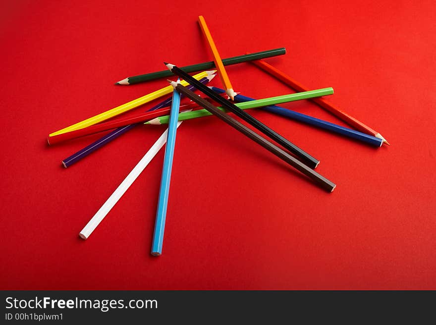 A Stack of Colored Pencils on Red Background - check my gallery for more pictures. A Stack of Colored Pencils on Red Background - check my gallery for more pictures