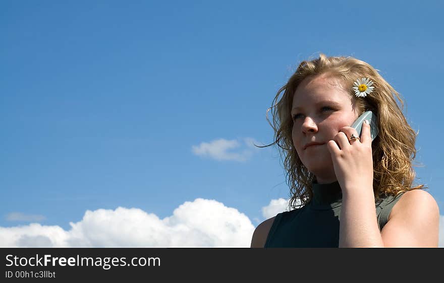 Girl talking on the phone on a sunny day