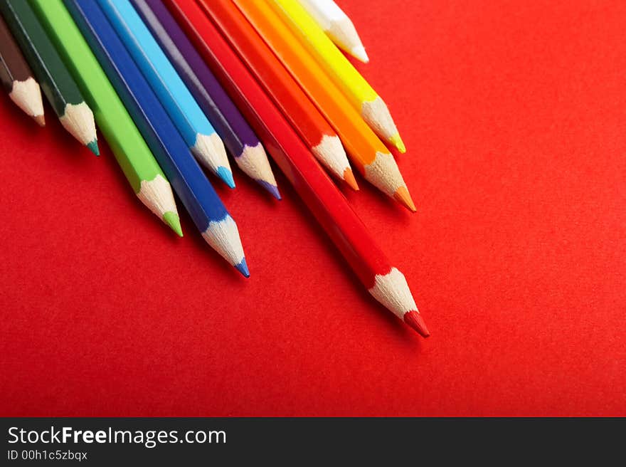 A Stack of Colored Pencils on Red Background - check my gallery for more pictures. A Stack of Colored Pencils on Red Background - check my gallery for more pictures