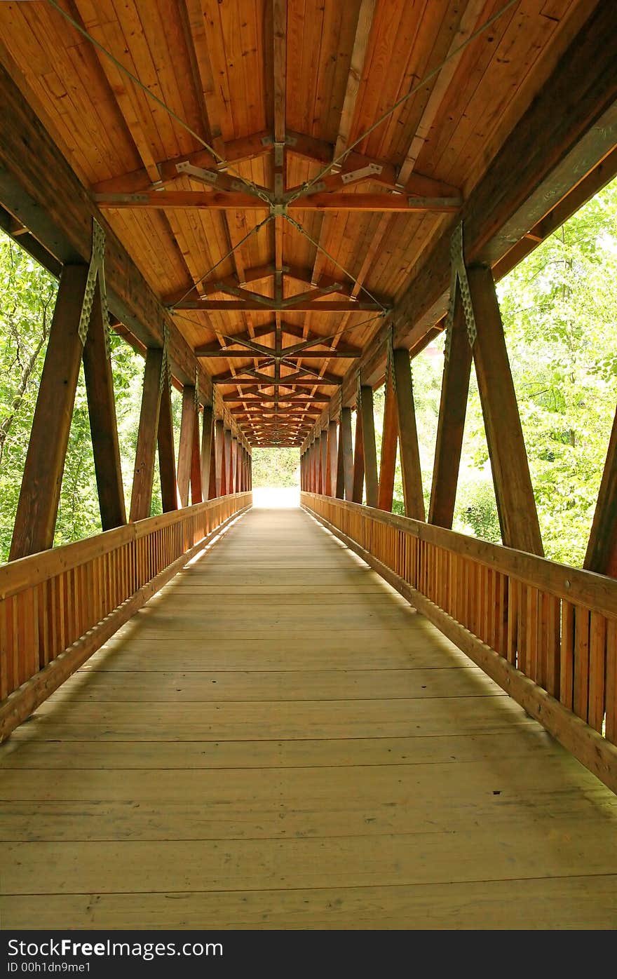 An old timber bridge into the distant daylight. An old timber bridge into the distant daylight