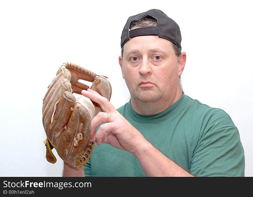 Man wearing a baseball glove and holding a ball. Man wearing a baseball glove and holding a ball.