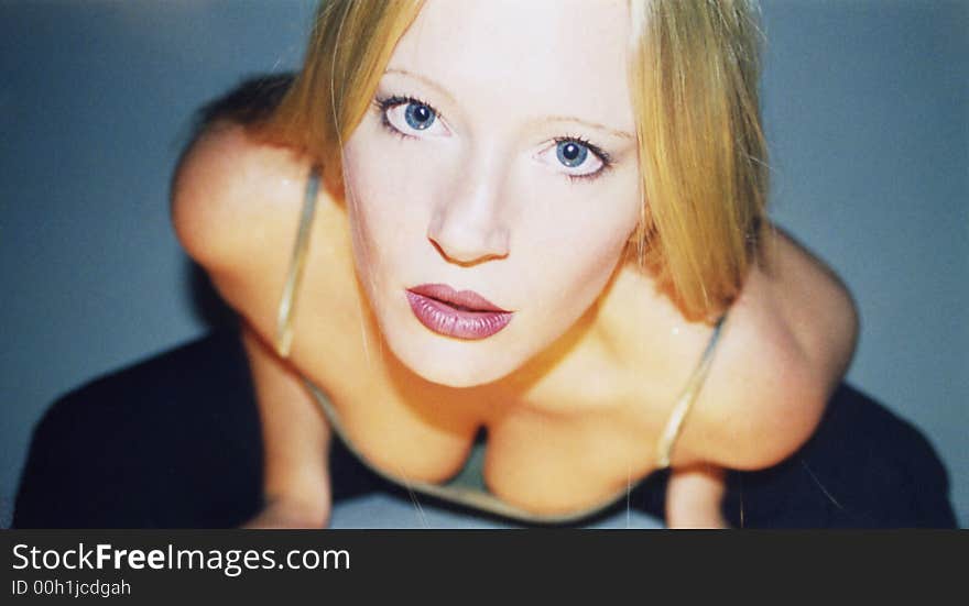 Beautiful blonde, blue-eyed woman in a sensual pose. Beautiful blonde, blue-eyed woman in a sensual pose
