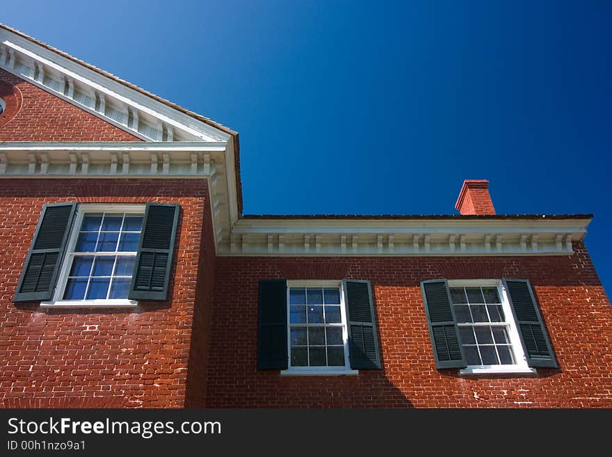 Classic brick house with blue sky background