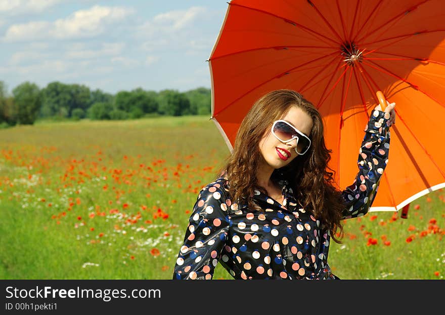 Happy young brunette with orange umbrella