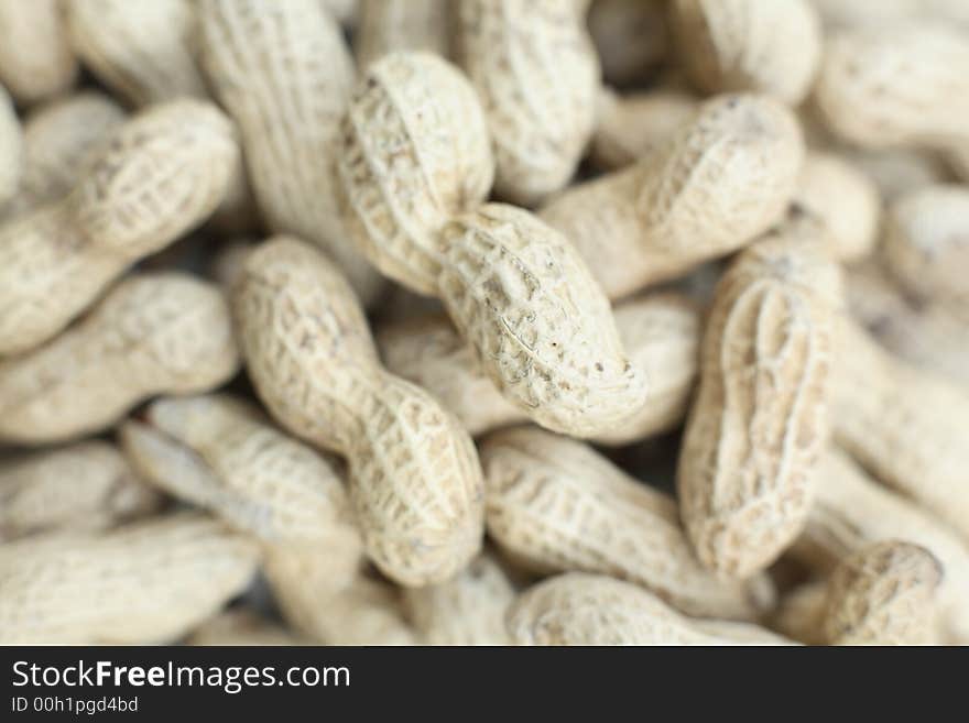 Close up of a pile of monkey nuts in the shells