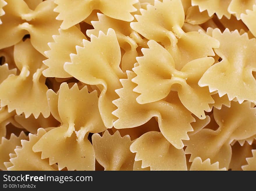 Uncooked farfalle dried pasta shapes. Uncooked farfalle dried pasta shapes