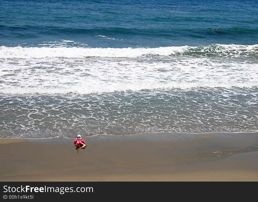 Lone toddler dangerously near the water's edge. Lone toddler dangerously near the water's edge