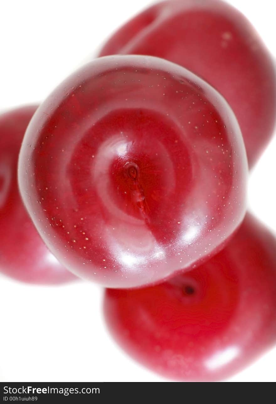 Close-up of stacked organic juicy plums on white background