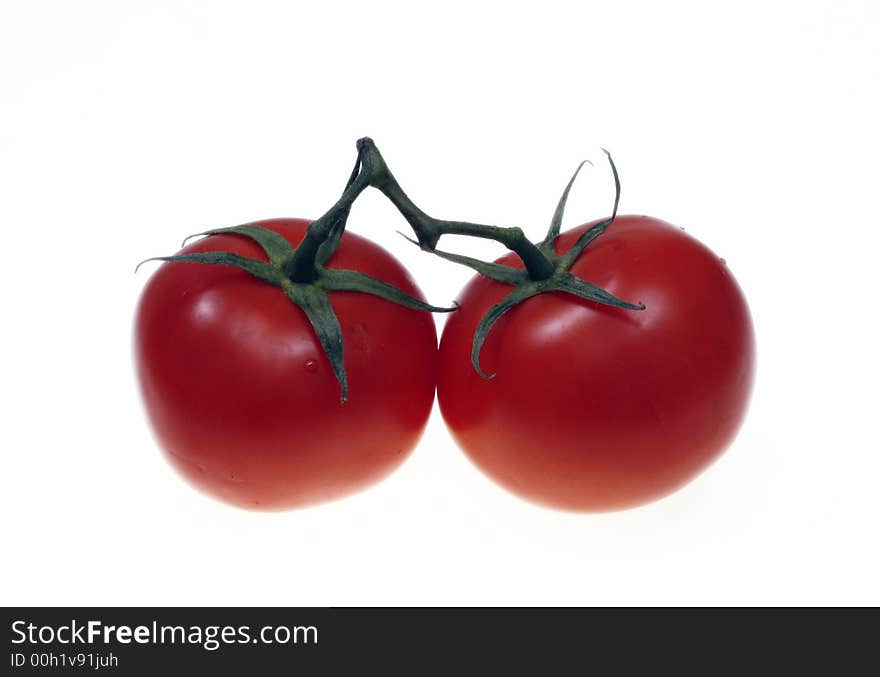 Two red tomatoes against a white background