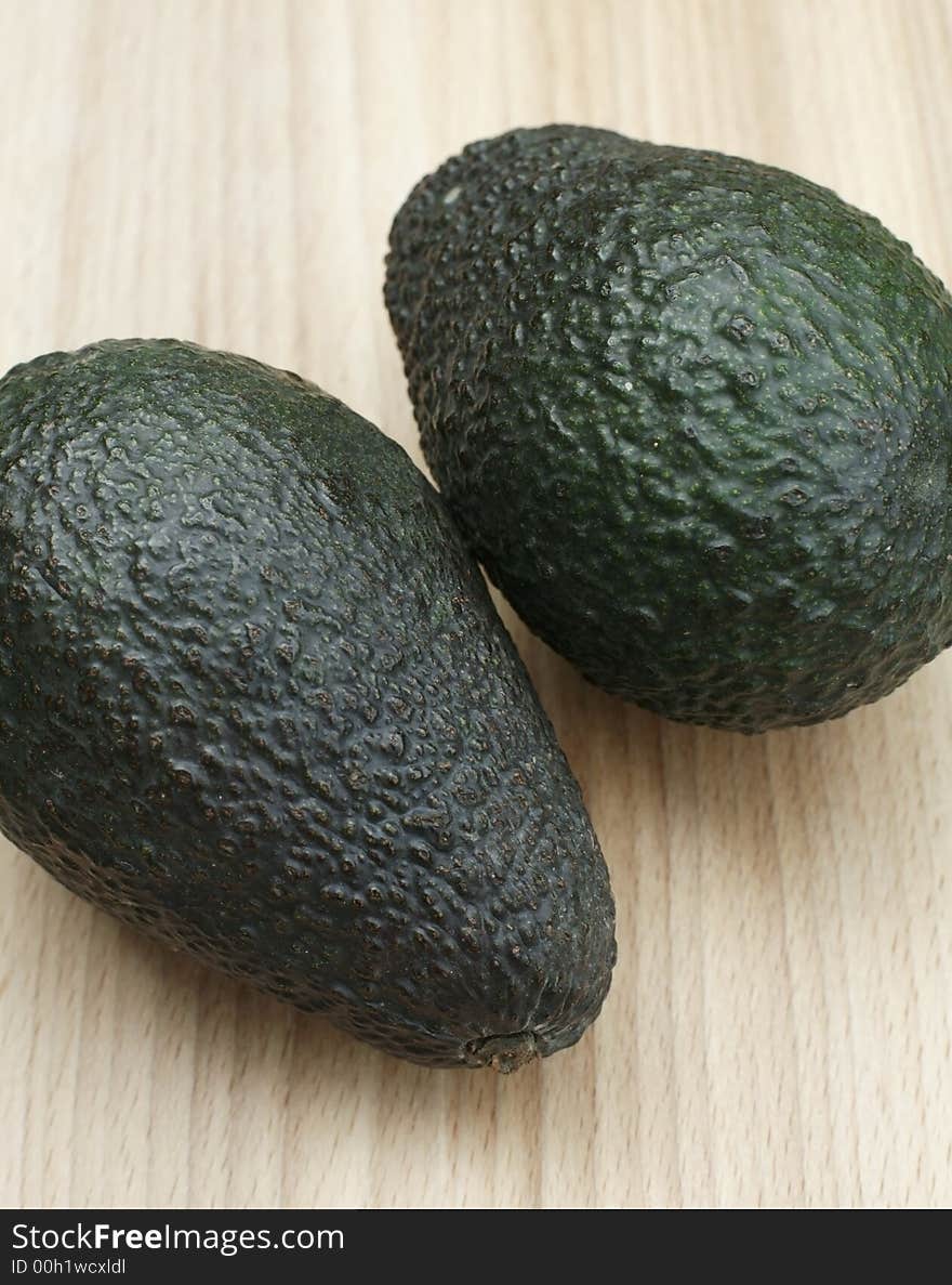 Two Fresh organic Avocados on chopping board