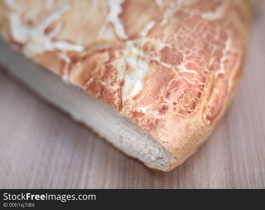 A loaf of fresh tiger bread on chopping board