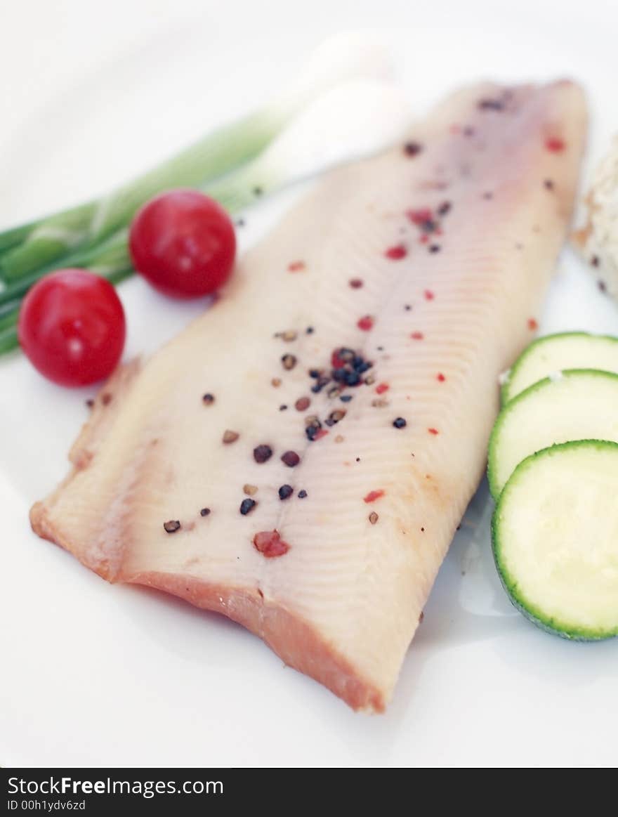 Fresh peppered trout with vegetables and salad