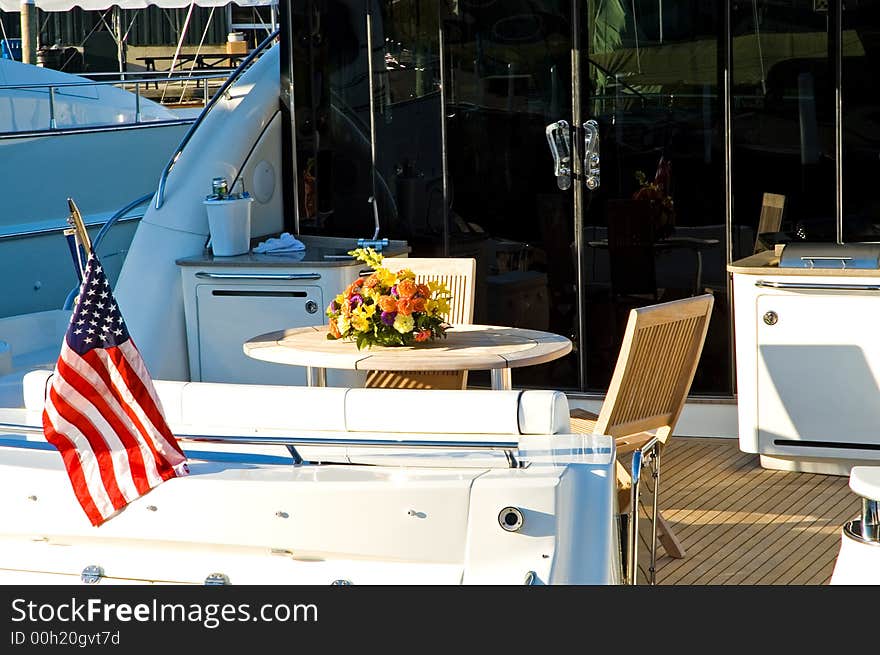 Aft deck of a private luxury yacht at a marina on an early spring morning.