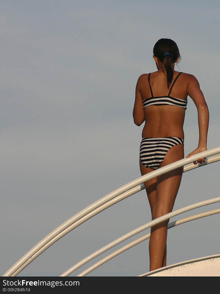 Young girl in swimsuit on the swimming pool