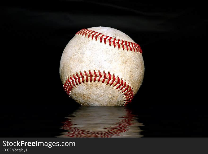 Closeup shot of a used baseball against a black background