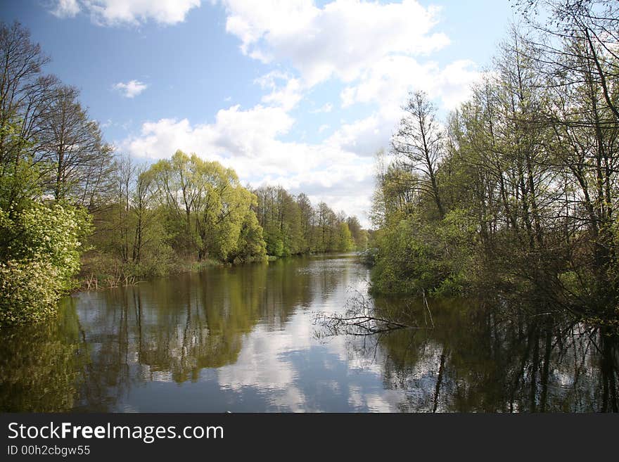 Channel landscape with clouds in spring