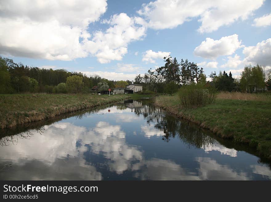 Channel landscape with clouds in spring