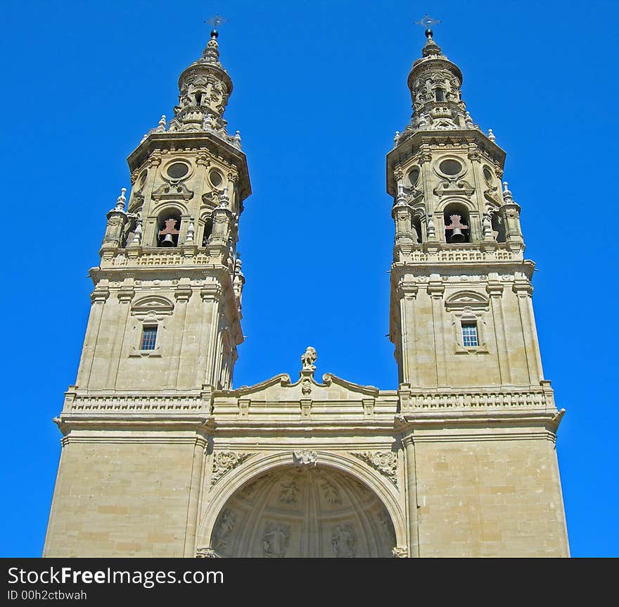 Two tall bell towers of cathedral reach up to clear blue sky. Two tall bell towers of cathedral reach up to clear blue sky