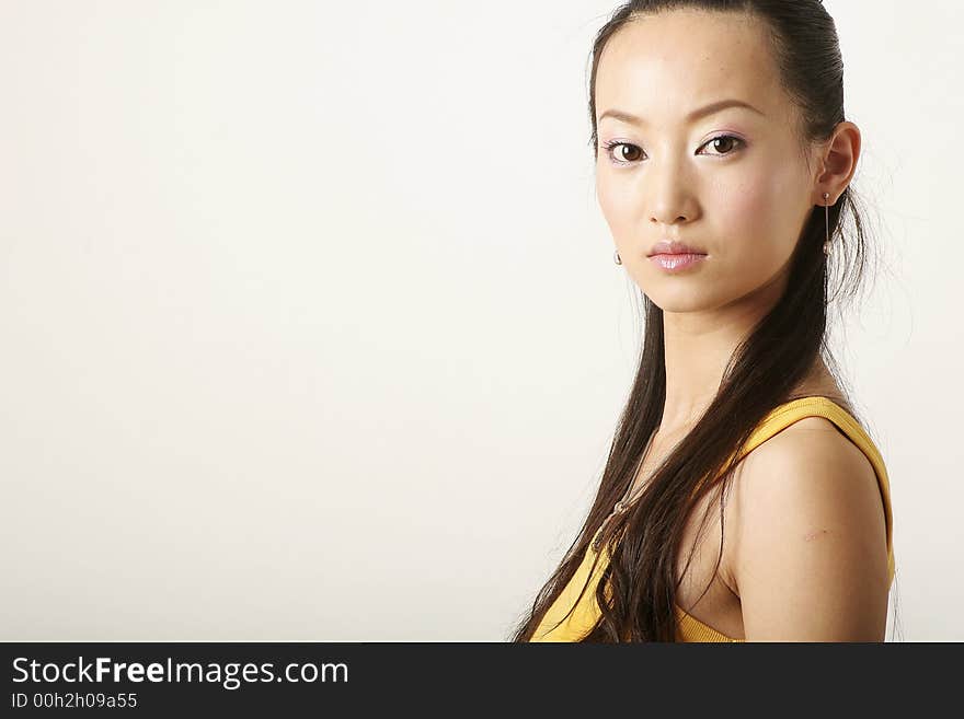 Beautiful Chinese girl in yellow gilet