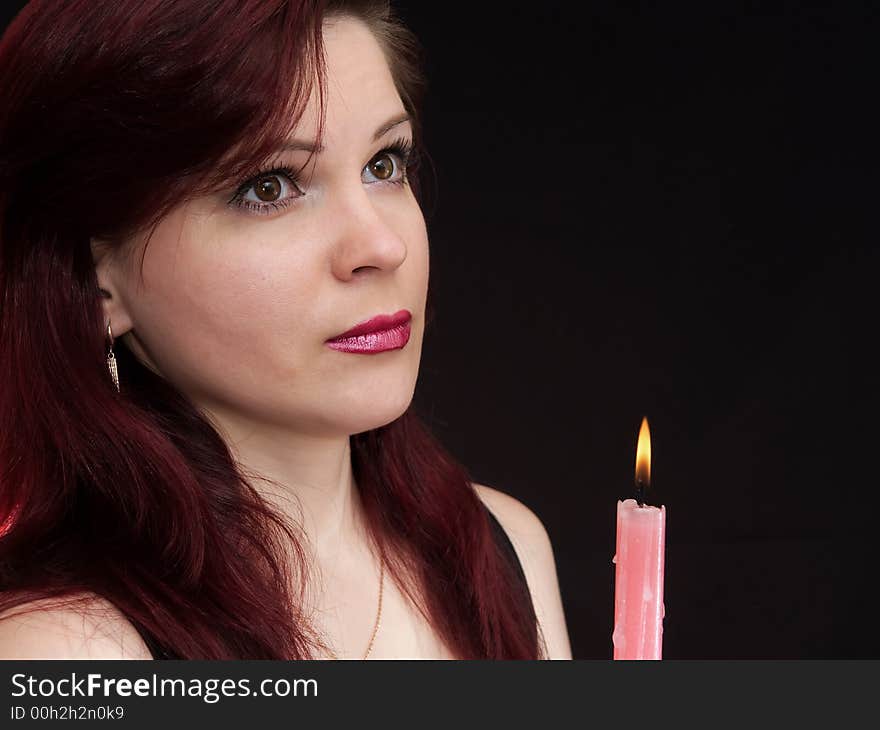 Girl and burning red candle. Girl and burning red candle