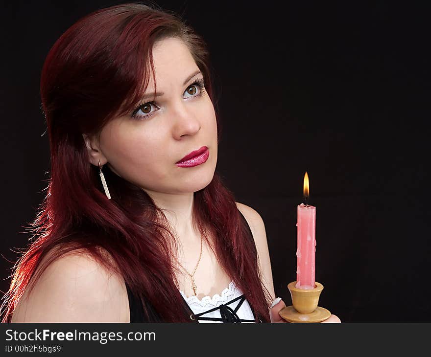 Girl and burning red candle. Girl and burning red candle