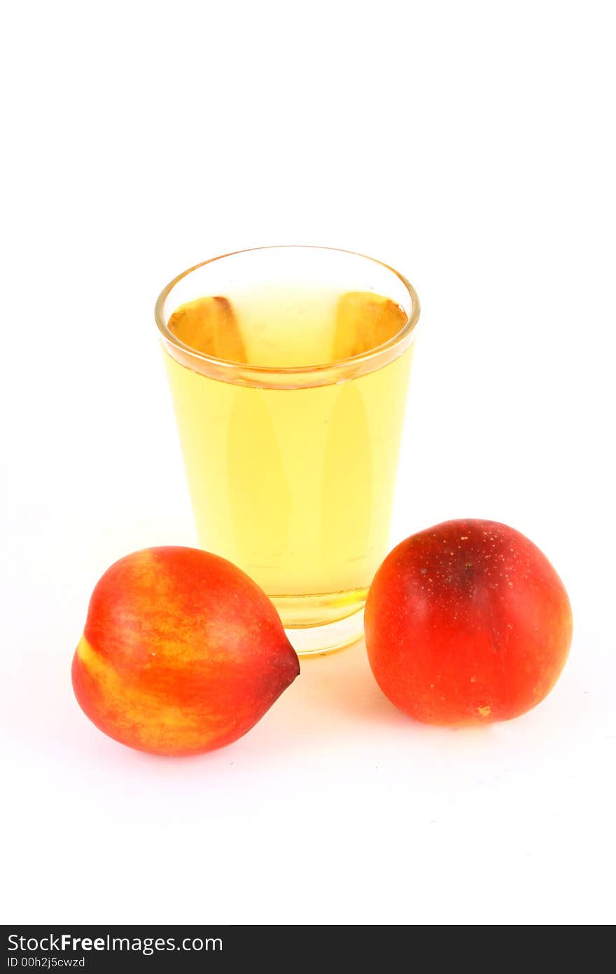 Glass of icetea and nectarine fruit - close-up. Glass of icetea and nectarine fruit - close-up