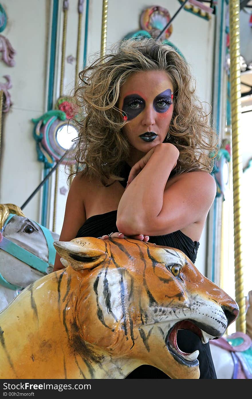 Fashion makeup model on carousel with tiger. Fashion makeup model on carousel with tiger