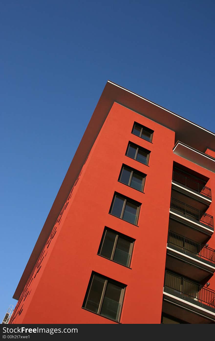 A red buildung in front of a blue sky. A red buildung in front of a blue sky