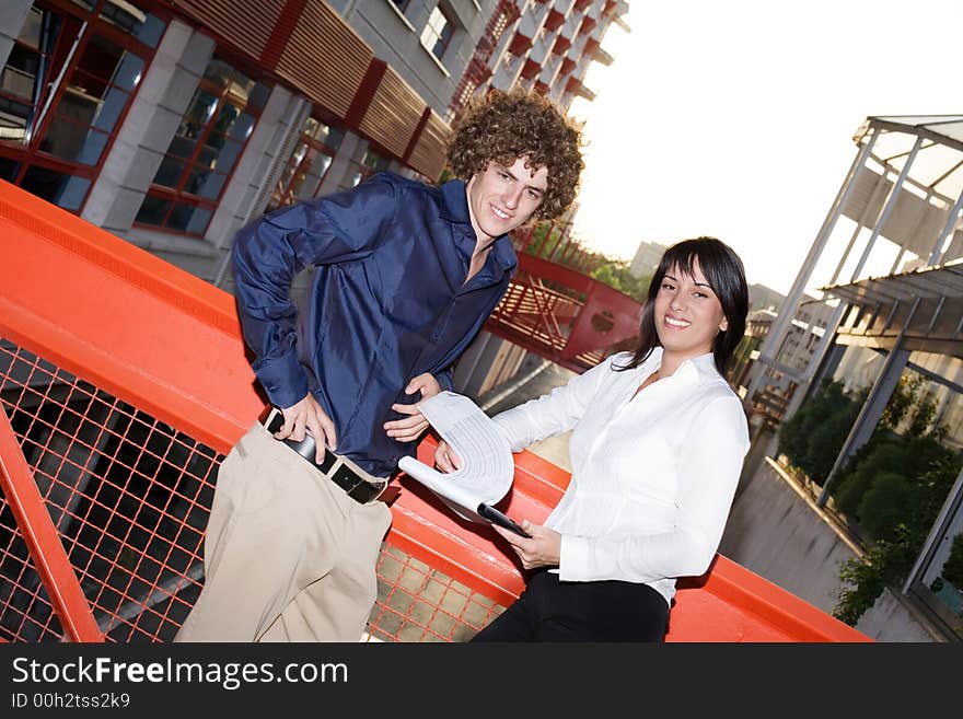 Two young business people discussing about work