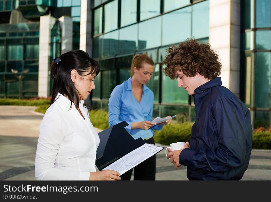 Group of young business people discussing business at the coffee break