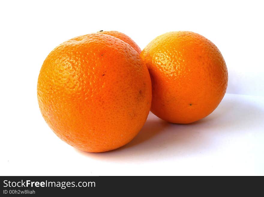 Three fresh oranges on a white background. Three fresh oranges on a white background