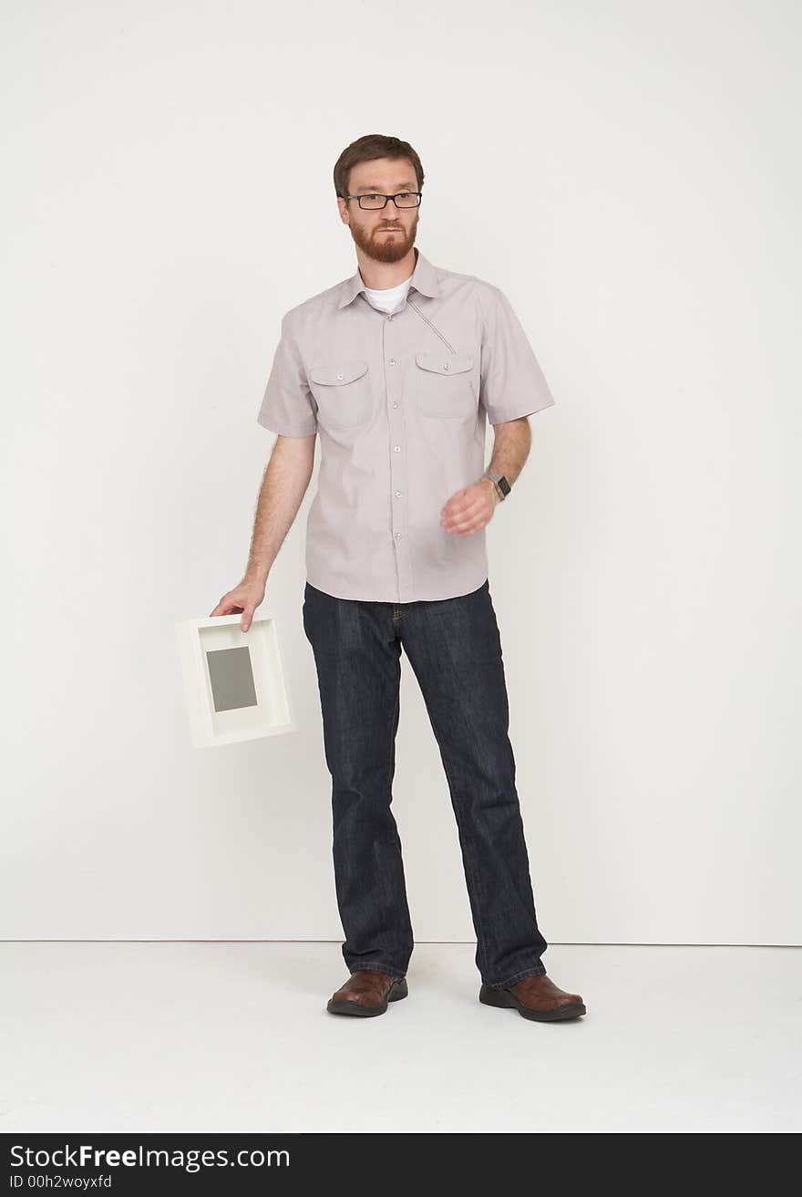 Man with glasses holding a frame and thinking. Man with glasses holding a frame and thinking.