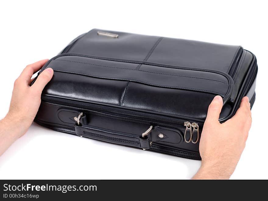 Male hands holding black briefcase over white background. Male hands holding black briefcase over white background