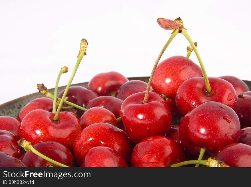 Photo of the plate with cherries on the white background. Photo of the plate with cherries on the white background