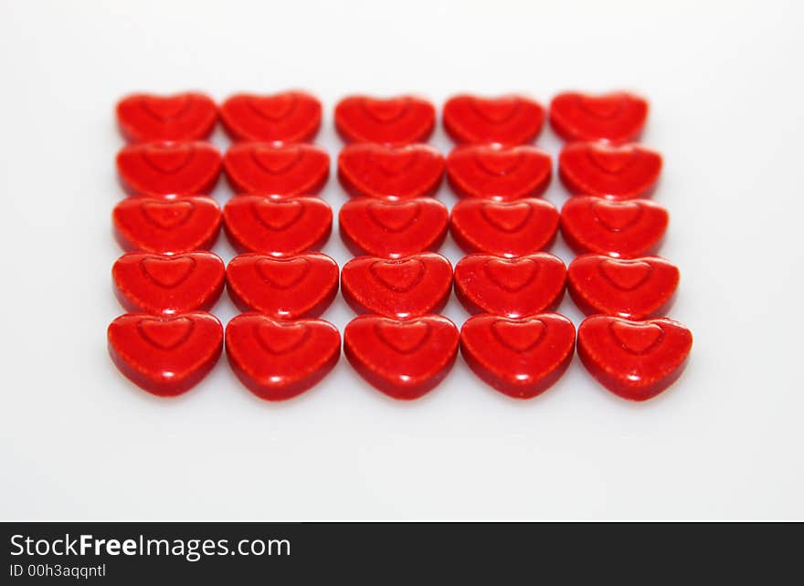 A close up of very red heart shaped candies. A close up of very red heart shaped candies