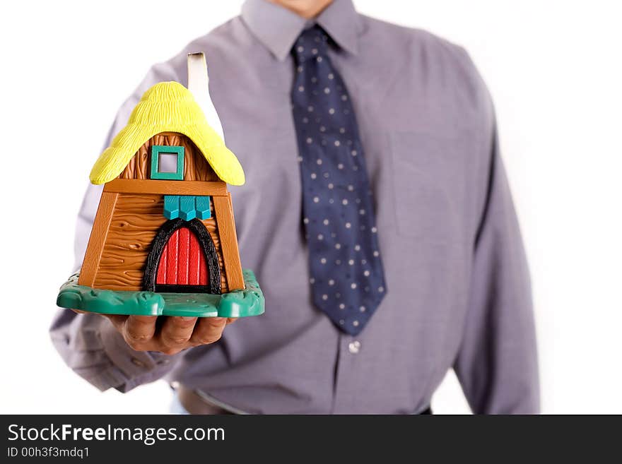 Man is holding a holida house, real estate concept. Man is holding a holida house, real estate concept