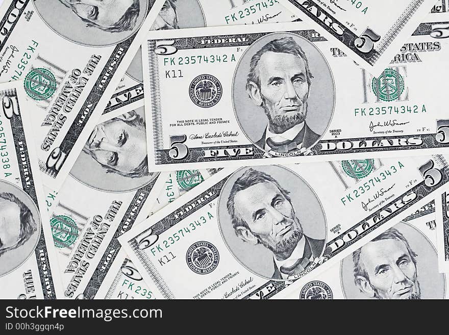 A close up of a bunch of 5 dollar bills, great background,. A close up of a bunch of 5 dollar bills, great background,