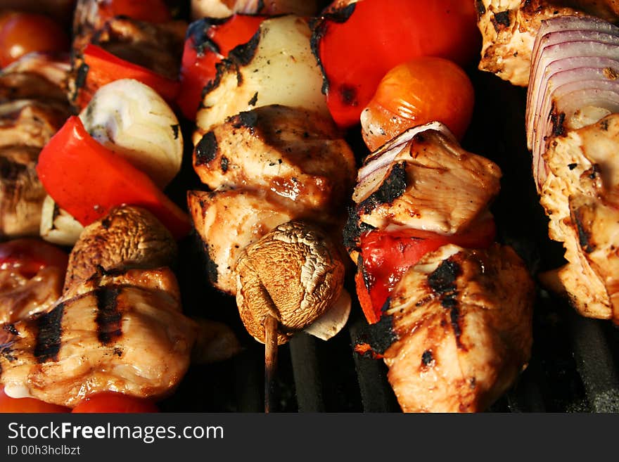 Skewered meat and vegetables on a grilling pin ready to be grilled. Skewered meat and vegetables on a grilling pin ready to be grilled.