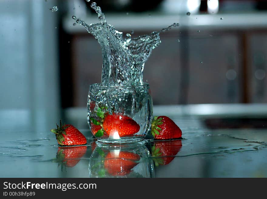 Strawberry and water spray on the table