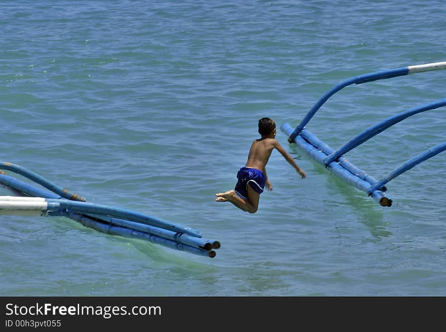 Boy diving from a boat into the cool water at summertime. Boy diving from a boat into the cool water at summertime