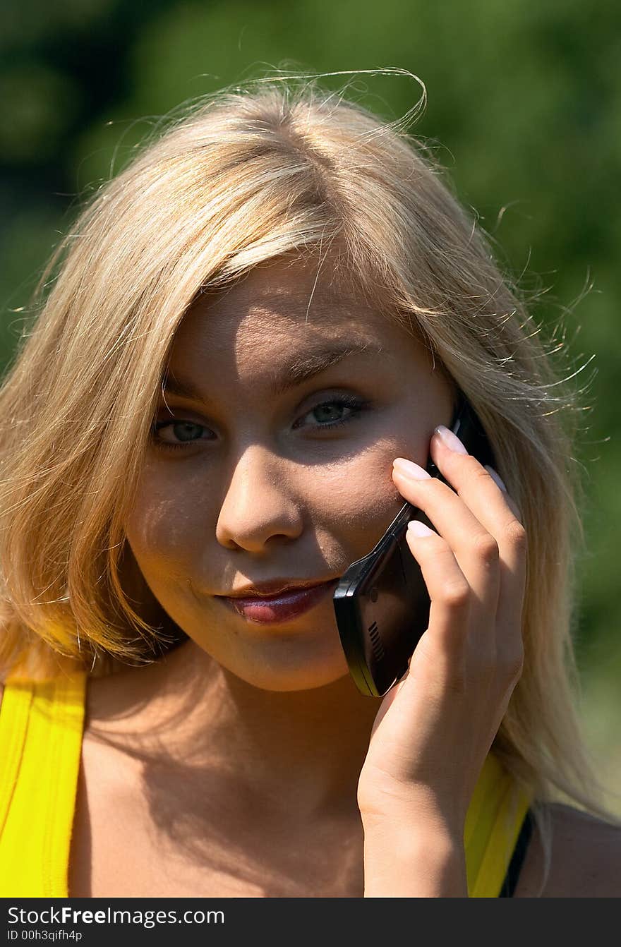 Blonde girl with cellphone in nature scenic. Blonde girl with cellphone in nature scenic