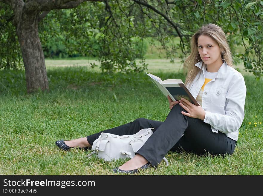 Girl reading book in the park. Girl reading book in the park