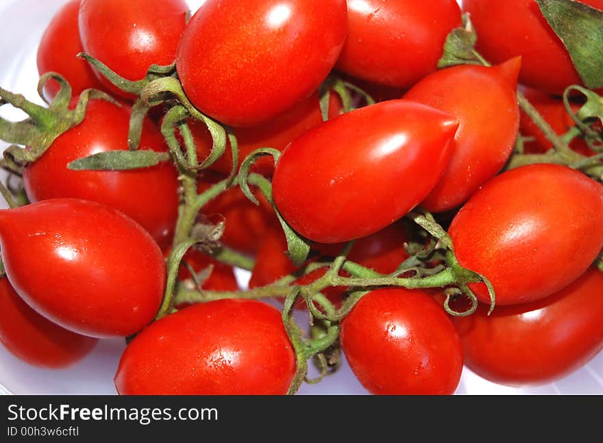 Fresh red tomatoes, white background