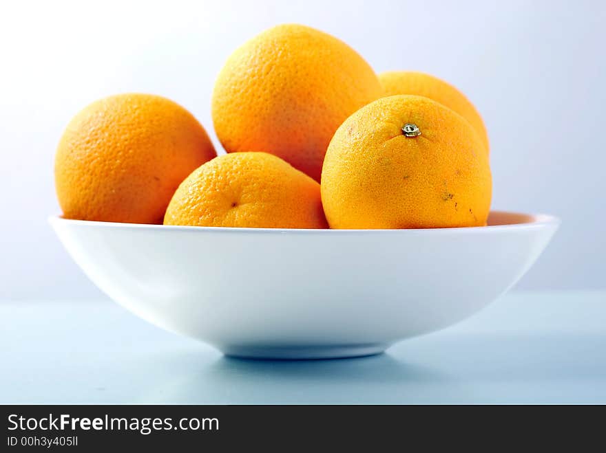 Orange fruits in white bowl. Orange fruits in white bowl