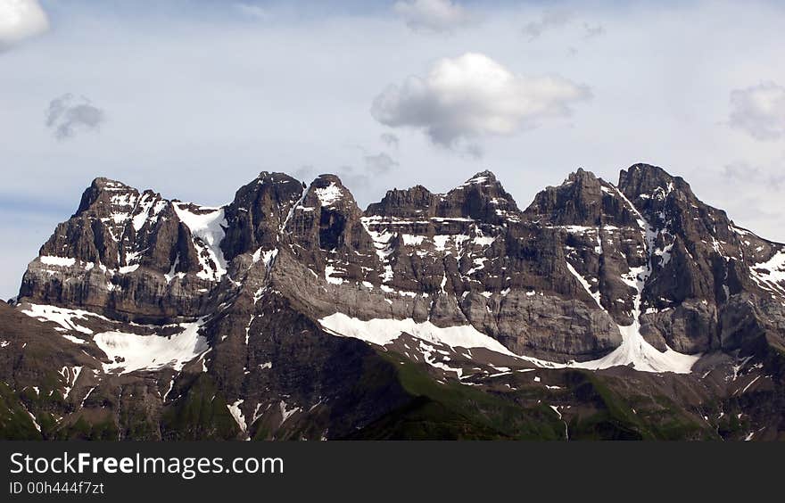 Detail view of the mountain range of Dents du Midi in Swiss Alps in summer (June). The peaks from left to write are Cime de l'Est (3178m), Forteresse (3164m), Cathedrale (3160m), Eperon (3114m), Dent Jaune (3186m), Doigts (3210m) and Haute Cime (3157m). Detail view of the mountain range of Dents du Midi in Swiss Alps in summer (June). The peaks from left to write are Cime de l'Est (3178m), Forteresse (3164m), Cathedrale (3160m), Eperon (3114m), Dent Jaune (3186m), Doigts (3210m) and Haute Cime (3157m).