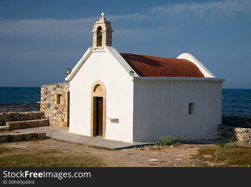 Old white church on sea coast