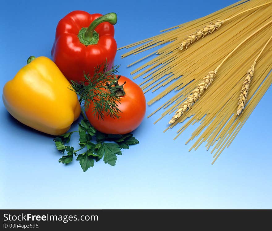 Spaghetti with vegetables on blue background. Spaghetti with vegetables on blue background