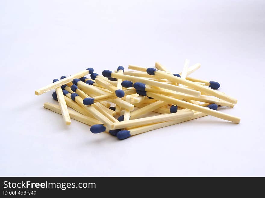 Huddle of matches with white background.